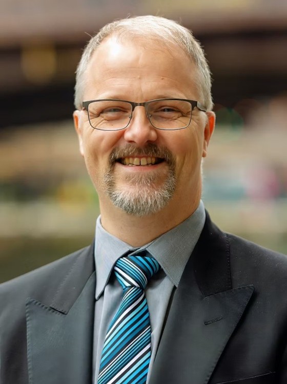 Headshot of  Getting off the Hamster Wheel - Strategies for Successfully Managing Project Management and Growth